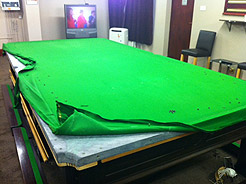 Example of cloth replacement on snooker table showing exposed slate bed